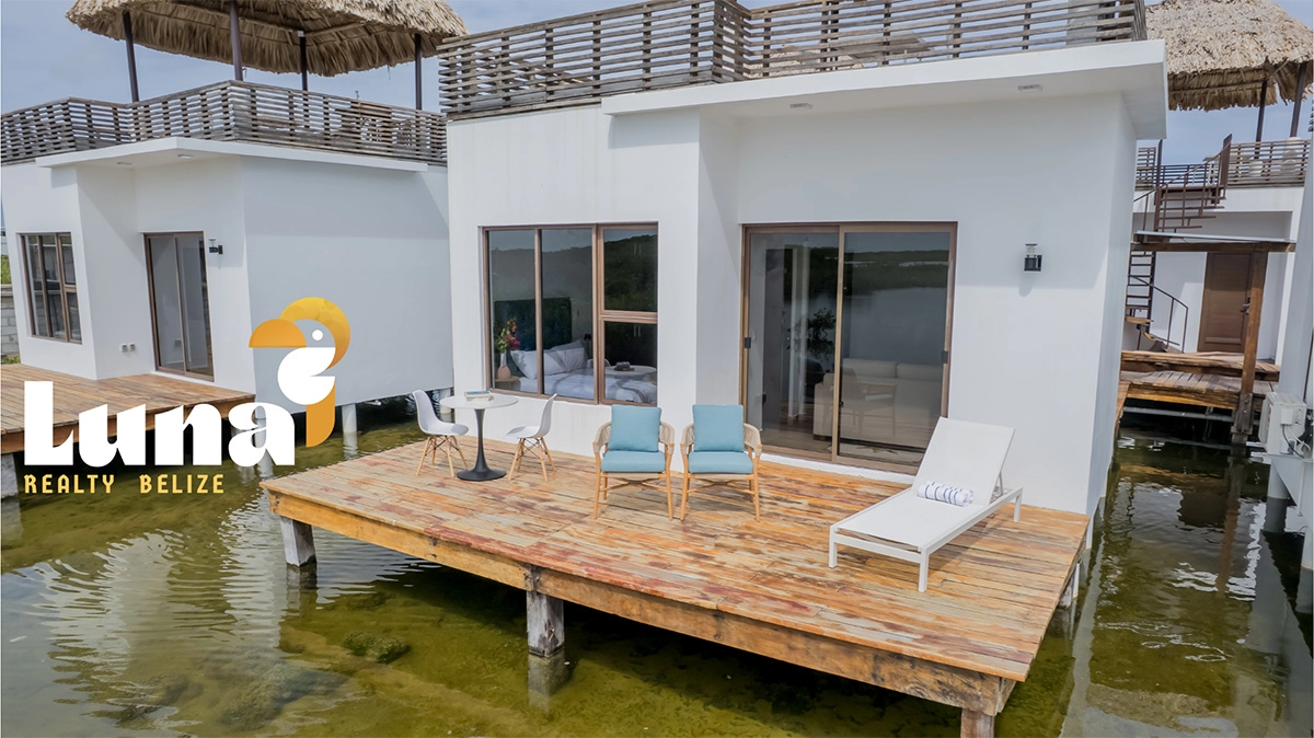 Overwater bungalow with deck and loungers.