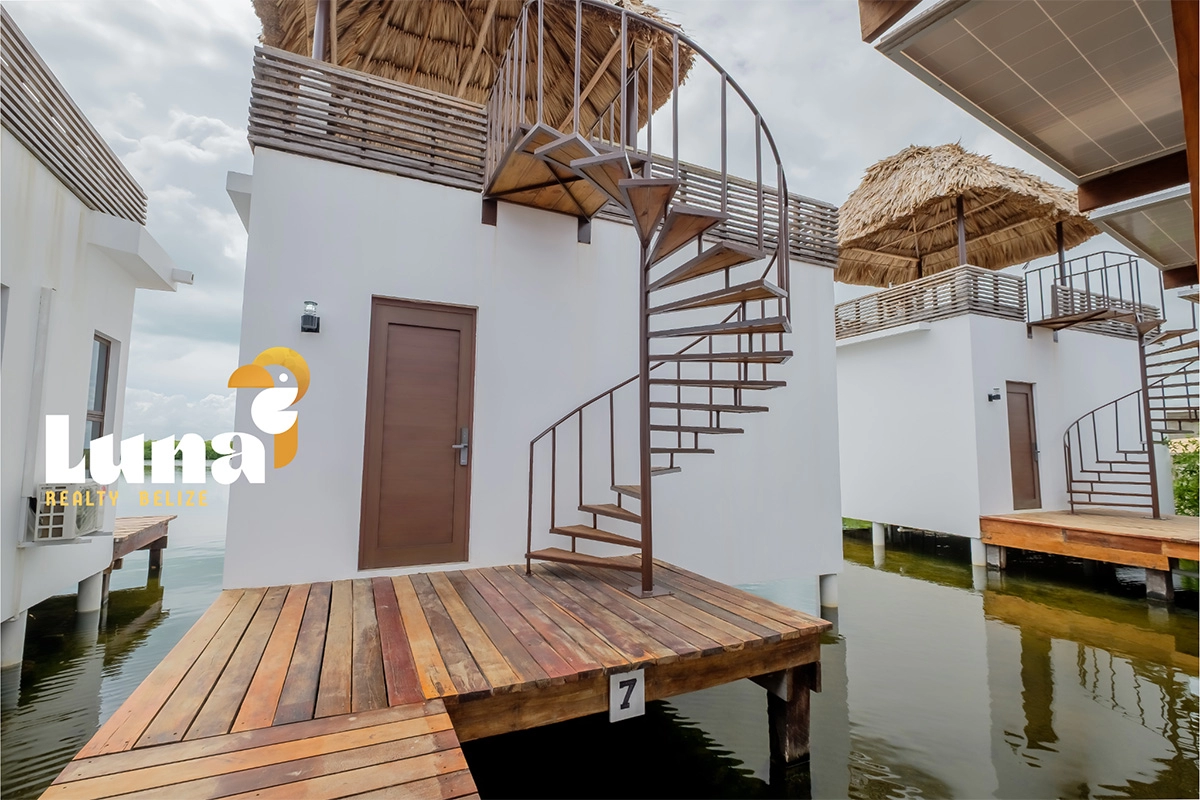 Overwater bungalows with spiral staircase and deck.