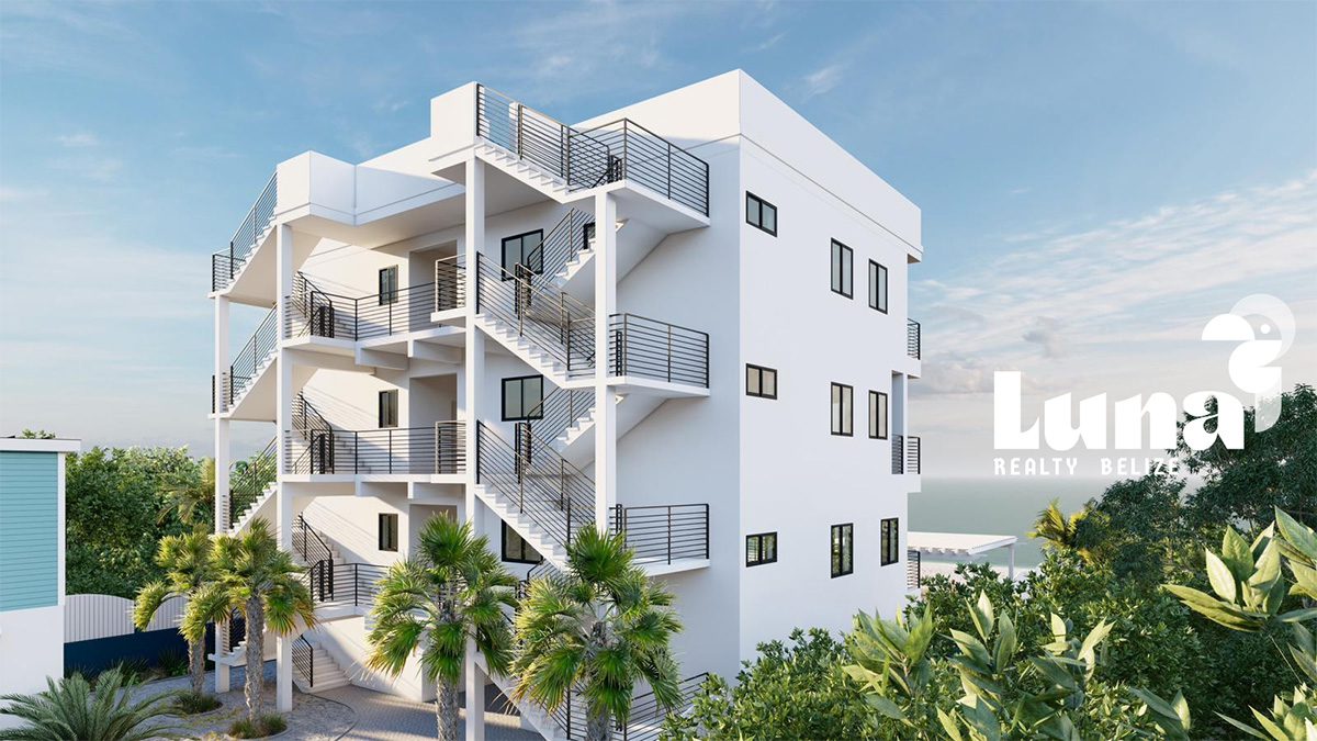 Modern white apartment building with palm trees.
