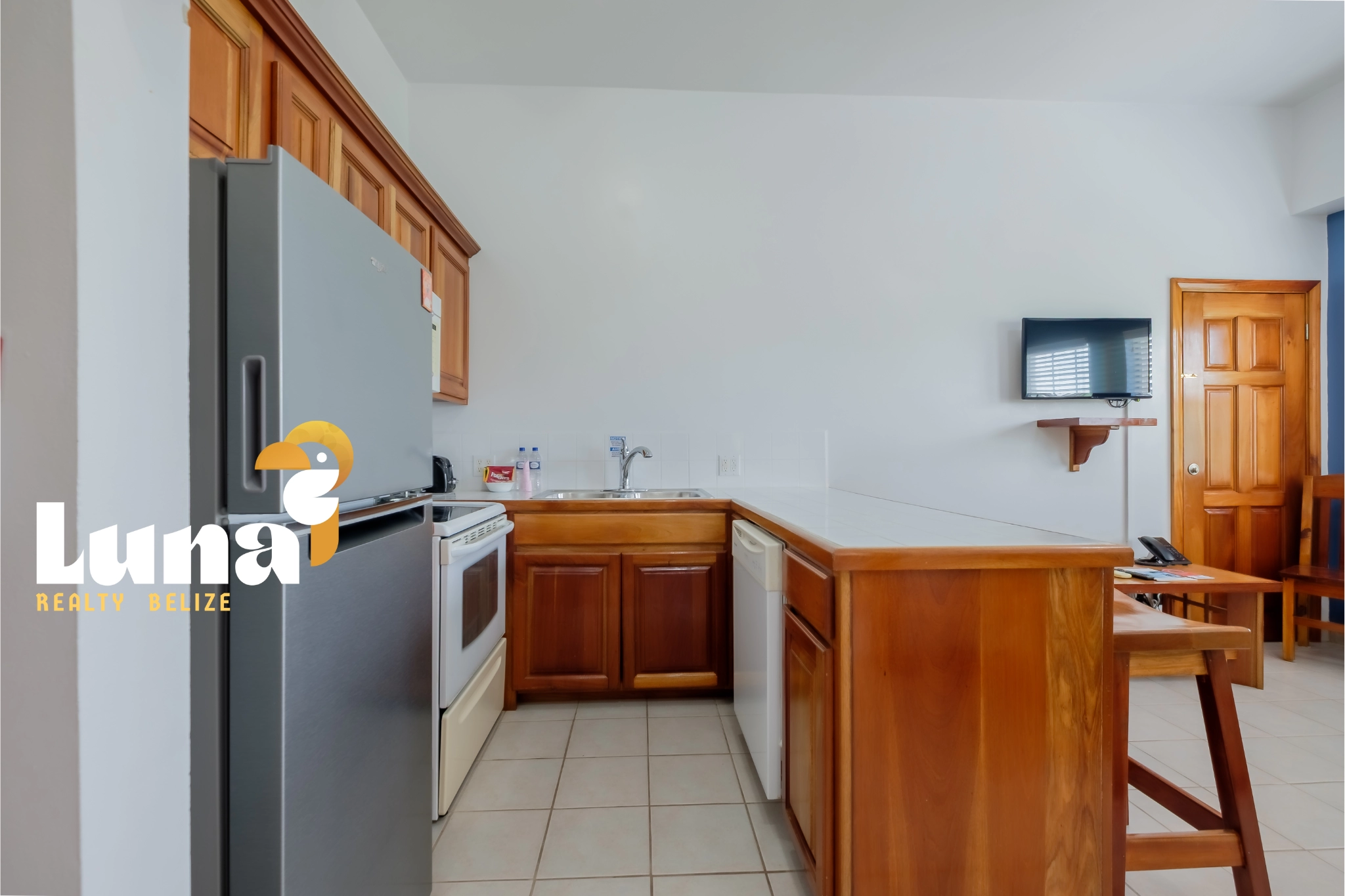 Modern kitchen with wooden cabinets and appliances.