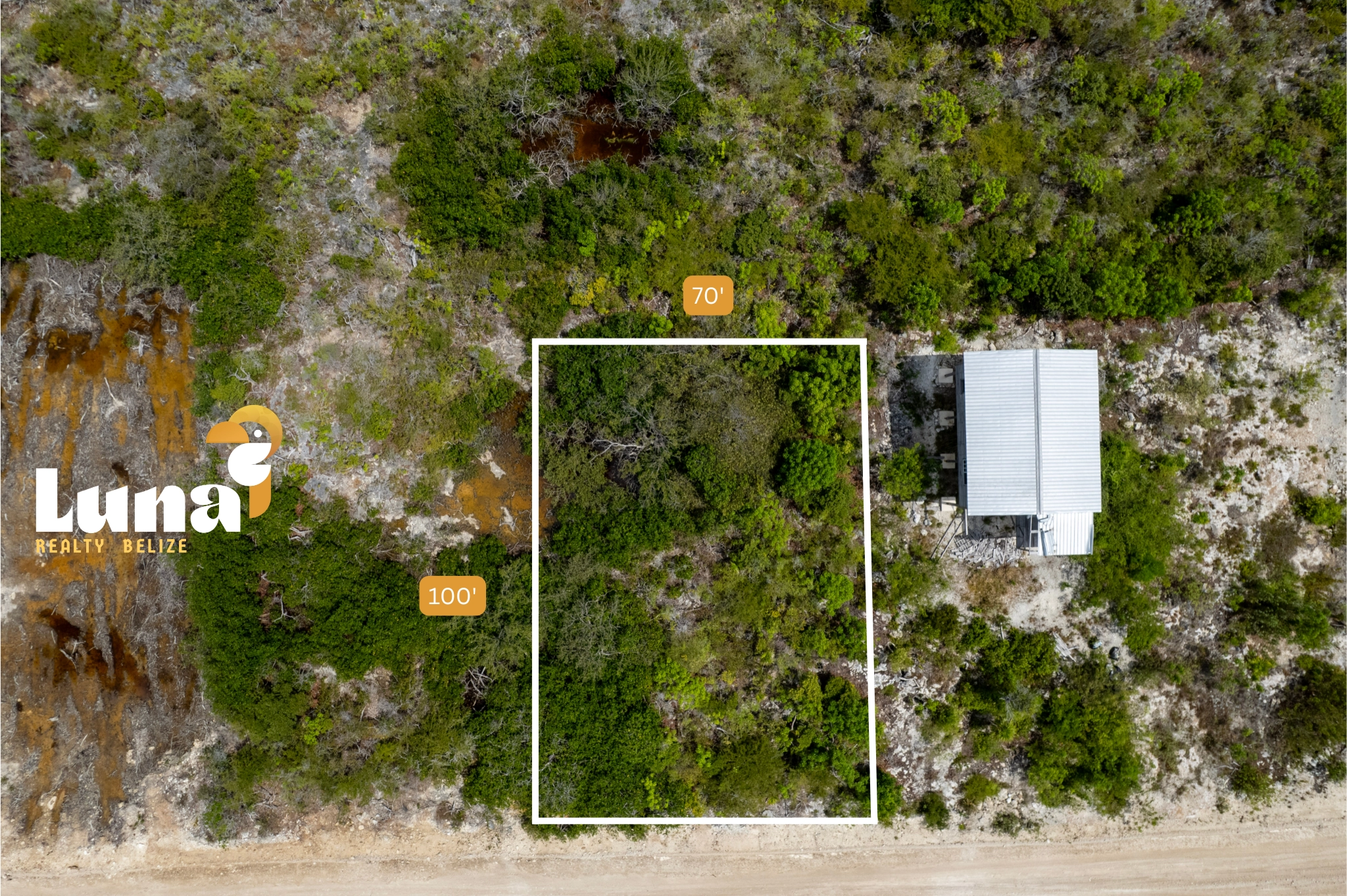 Aerial view of land plot and building.
